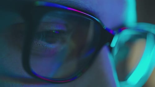 Person with Glasses and Reflection of Code