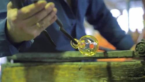 Glass Artist Forming Molten Glass with Tools