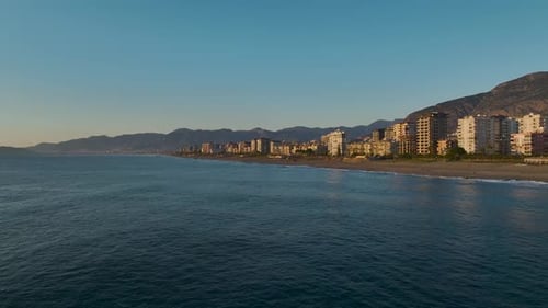 Aerial Video of Calm Ocean Sunset Over Sandy Coastline