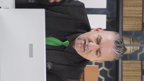 Adult Speaking During Online Meeting Wearing Dark Suit