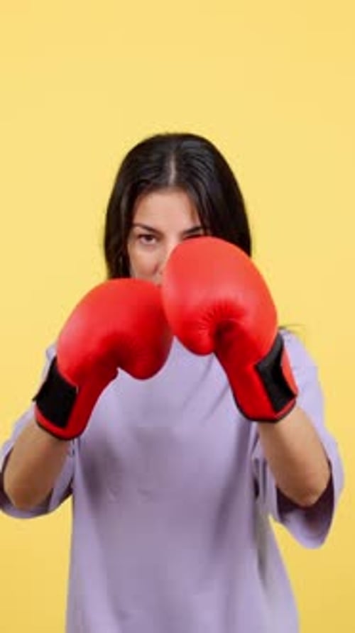 Woman Boxer in Red Gloves Ready to Fight