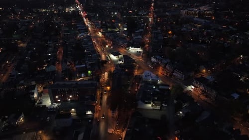 Street fork in american town at night. Lighting lantern along road in small historic city. Aerial to