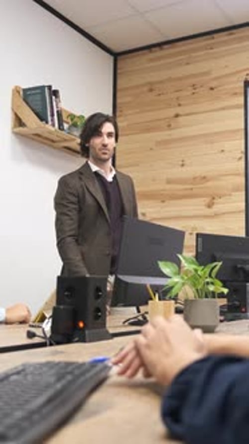 Man Talking to Colleagues in Modern Office