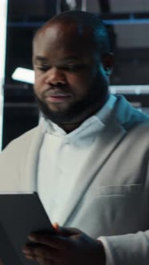 Businessman in Suit Uses Tablet in Office