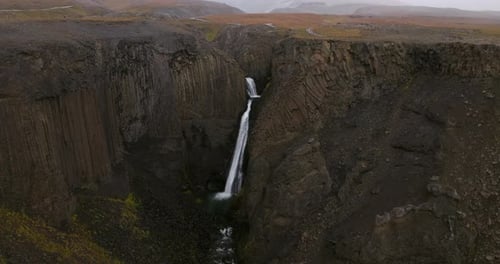 Waterfall Litlanesfoss During Snowfall In Iceland - Drone Shot