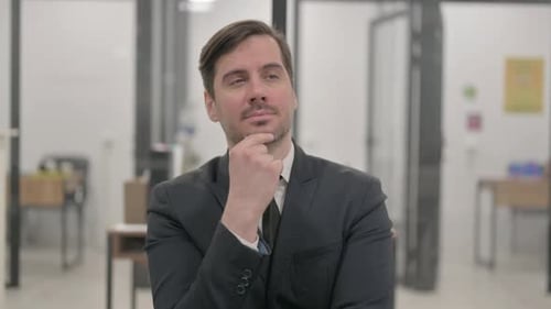 Man in Suit Thinking, Has an Idea