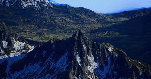 Majestic Mountain Peak Rising Above Lush Green Valleys During Dawn