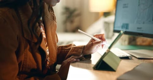 Woman Using Stylus and Tablet at Desk