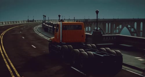 Truck Travels Along a Winding Road Under Moonlit Skies Near the Bridge