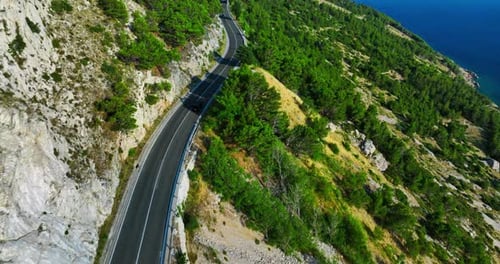 Aerial View of Coastal Road and Mountainous Landscape