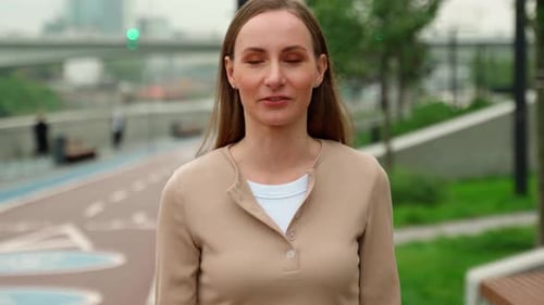 Woman Talking in Urban Park on Overcast Day