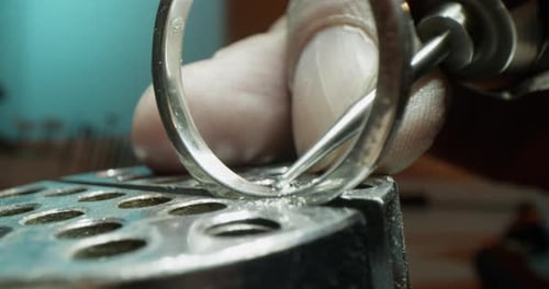 Crop Jeweler Making Hole in Ring