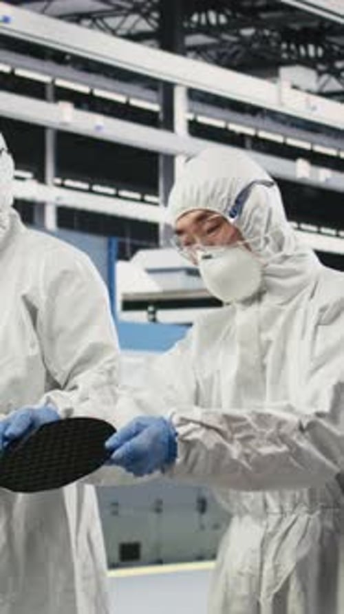 Vertical Video Carrying Silicon Wafer Engineering and Multiethnic Team Coworkers
