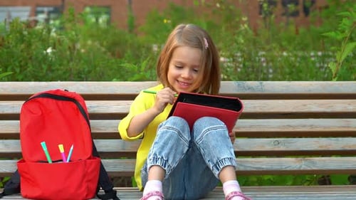 Little Student Girl Sits in Schoolyard and Write Education Preschool School