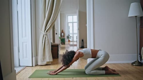 Woman Doing Yoga Stretch on Exercise Mat Indoors