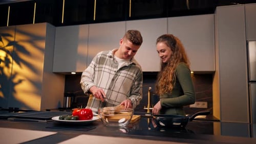Young Couple Cooking Together in Modern Kitchen