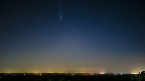 Glowing Comet in Starry Night Sky Above City