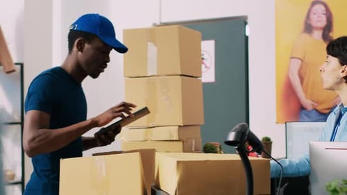 Man Checks Shipping Inventory on Tablet in Store