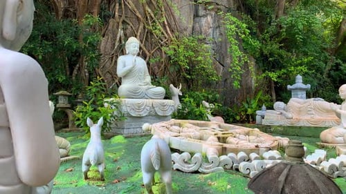 Serene White Buddha Statues in a Peaceful Zen Garden Setting