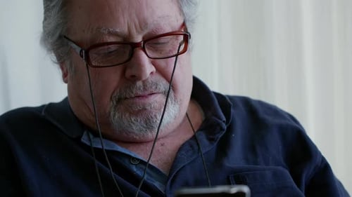 Senior Man Using Smartphone Indoors
