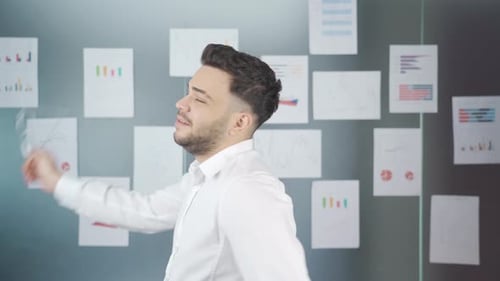 Confident Man Presents Data in Modern Office