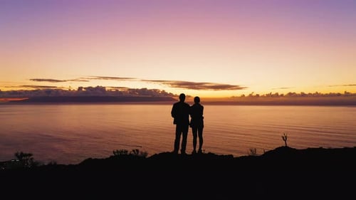 Couple Silhouette Man and Woman Two Tourists Stand on the Top of Mountain with Ocean View During