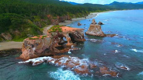 Top view of amazing cliffs of sea coast. Clip. Rocks with erosion of sea waves create amazing stone