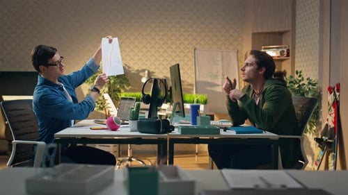 Business Coworkers Discussing Project Together at Office Man Crumpling Paper