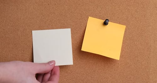 Hand Pins Blank Note on Cork Board