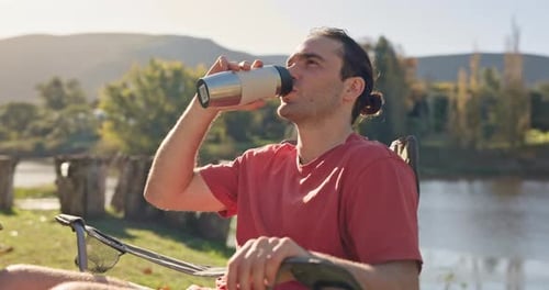 Camping, relax and man with coffee in nature for holiday, vacation or adventure in woods