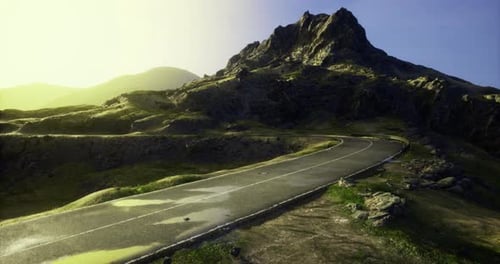 Winding Road to a Mountain at Sunrise in a Peaceful Landscape