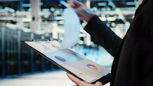 Data Center Admin Verifying Infrastructure Status with Clipboard Files Closeup