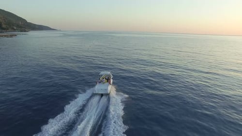 Motorboat Gliding on Ocean at Sunset Aerial View