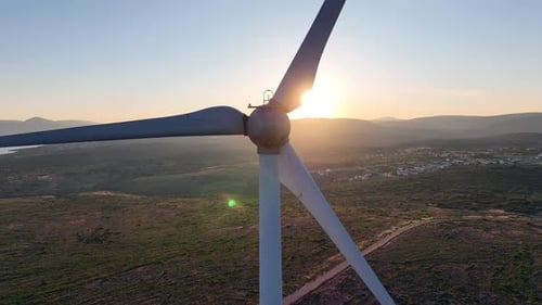 Wind Turbine Spinning at Sunset in Rural Environment