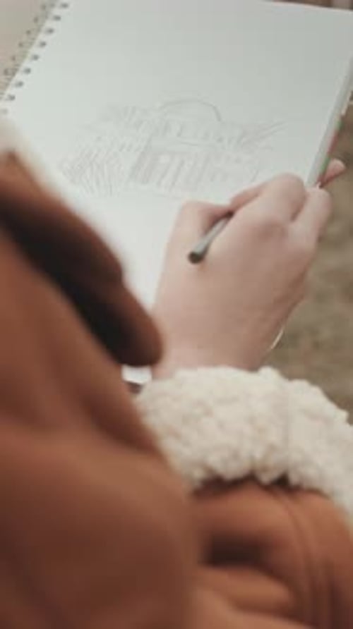 Female Artist Drawing Sketch of Building Outdoors