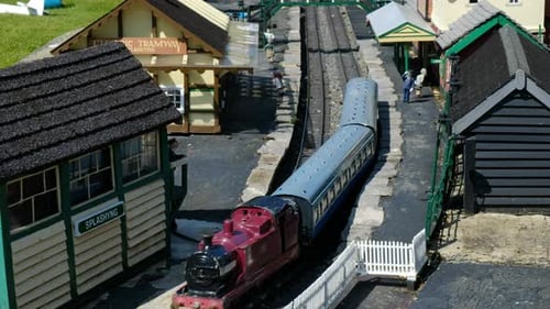 Model Village and Railway Featuring Old Locomotive Departing Train Station in an English Town with G