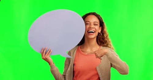 Woman, face and pointing to speech bubble on green screen for social media or advertising