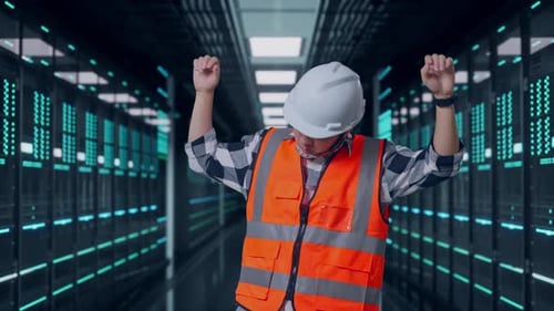 Asian Male Engineer Screaming Goal And Dancing Celebrating in Data Center