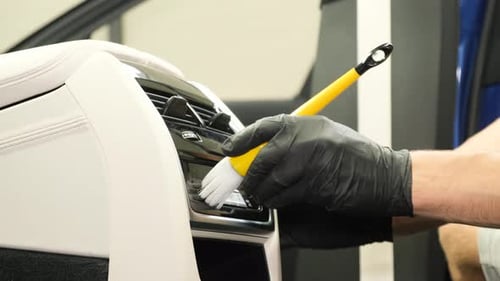 Close Up Man Cleaning Car Interior Air Vent