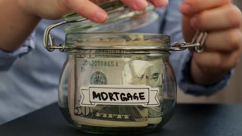 Saving Money in Mortgage Jar Close Up