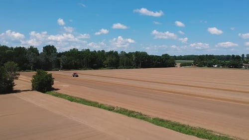 Tractor at Work Preparing the Field for the Upcoming Planting Season