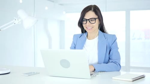 Woman Using Laptop for Video Conference in Office