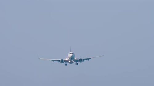Passenger Airplane Flying Through Cloudy Sky