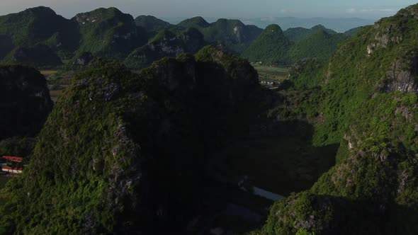 Rise over lush green mountain range in Tam Coc Vietnam, sunrise aerial ...