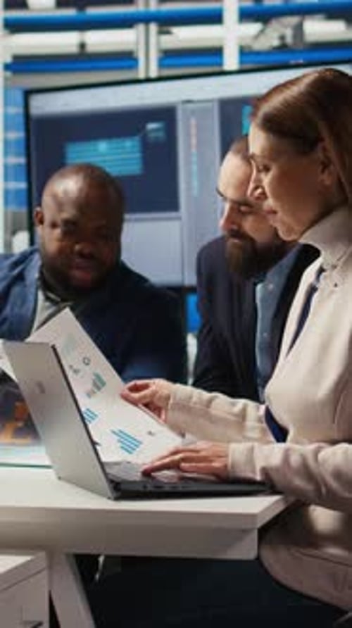 Vertical Video Factory Manager Looking Over Paperwork Files Developing Business Model