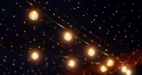Warm Hanging String Lights Glowing Over an Outdoor Evening Scene