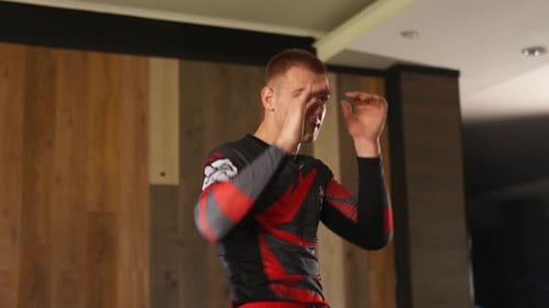 Martial Artist Practices Moves in a Studio