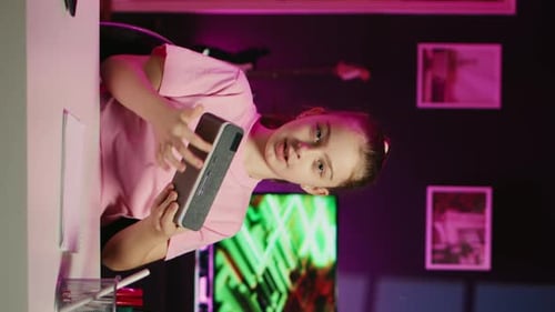 Girl Talking and Holding Game Console in Bedroom