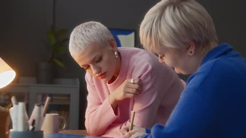 Young Adults Writing Together Indoors