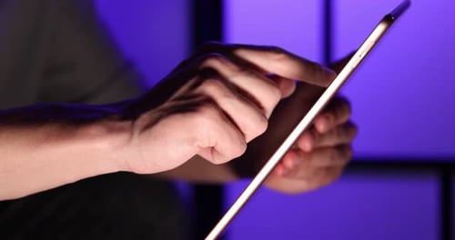 Man using modern tablet indoors, closeup view